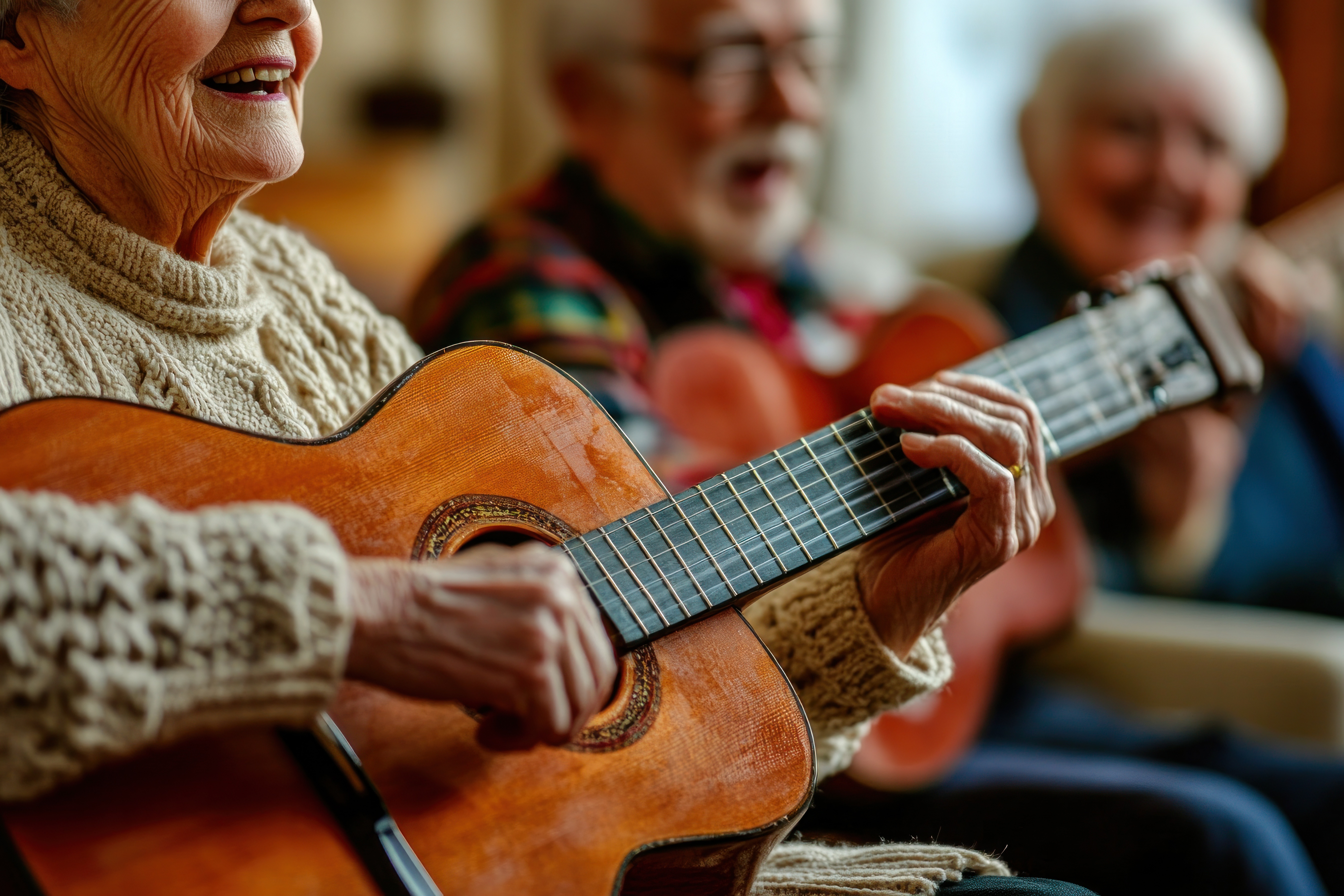 Woman playing guitar with two other people singing along