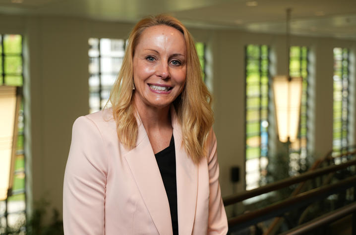 Woman blonde hair, pink blazer and black blouse
