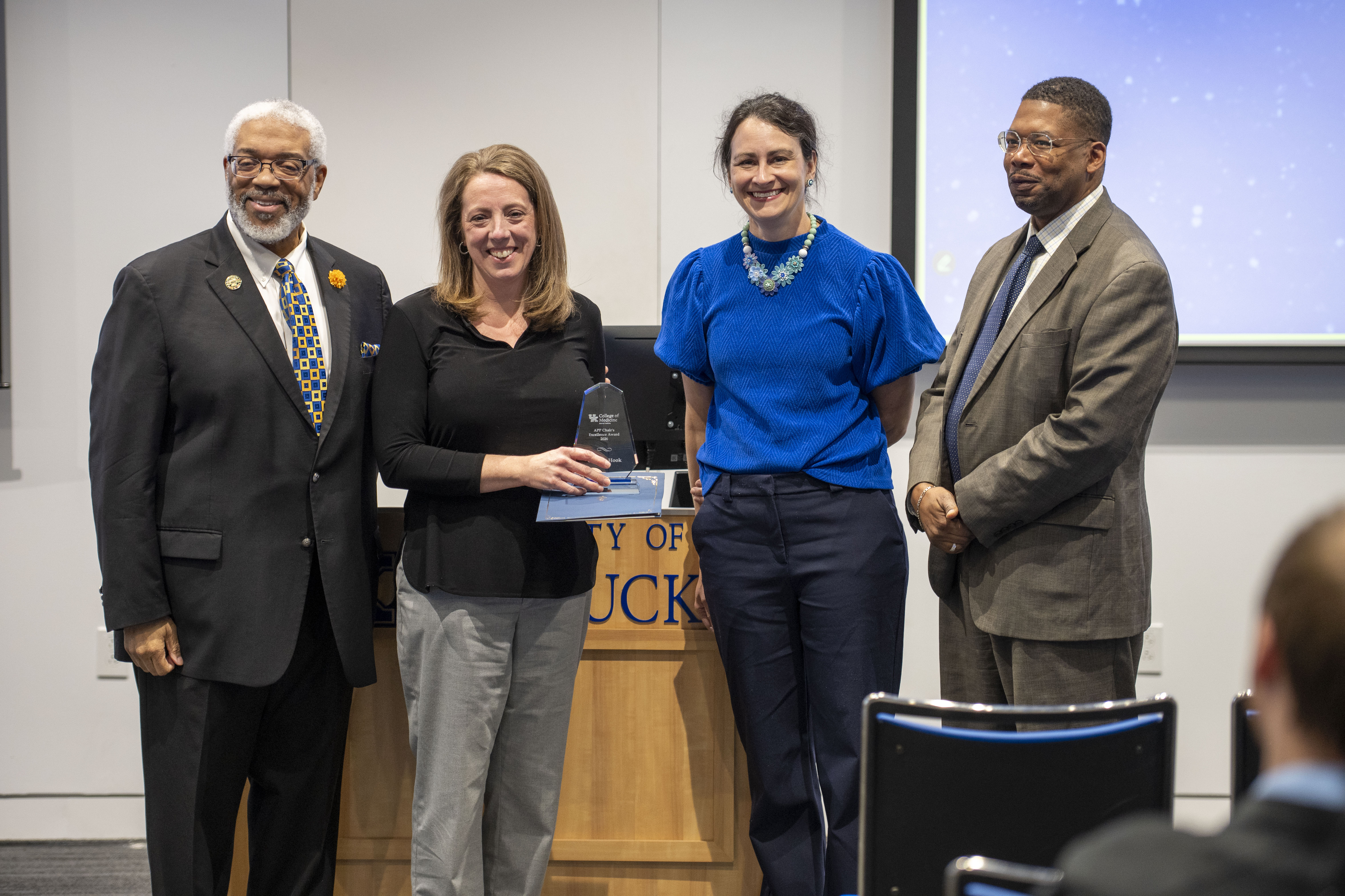 Corinne Hook stands with leadership while receiving her award