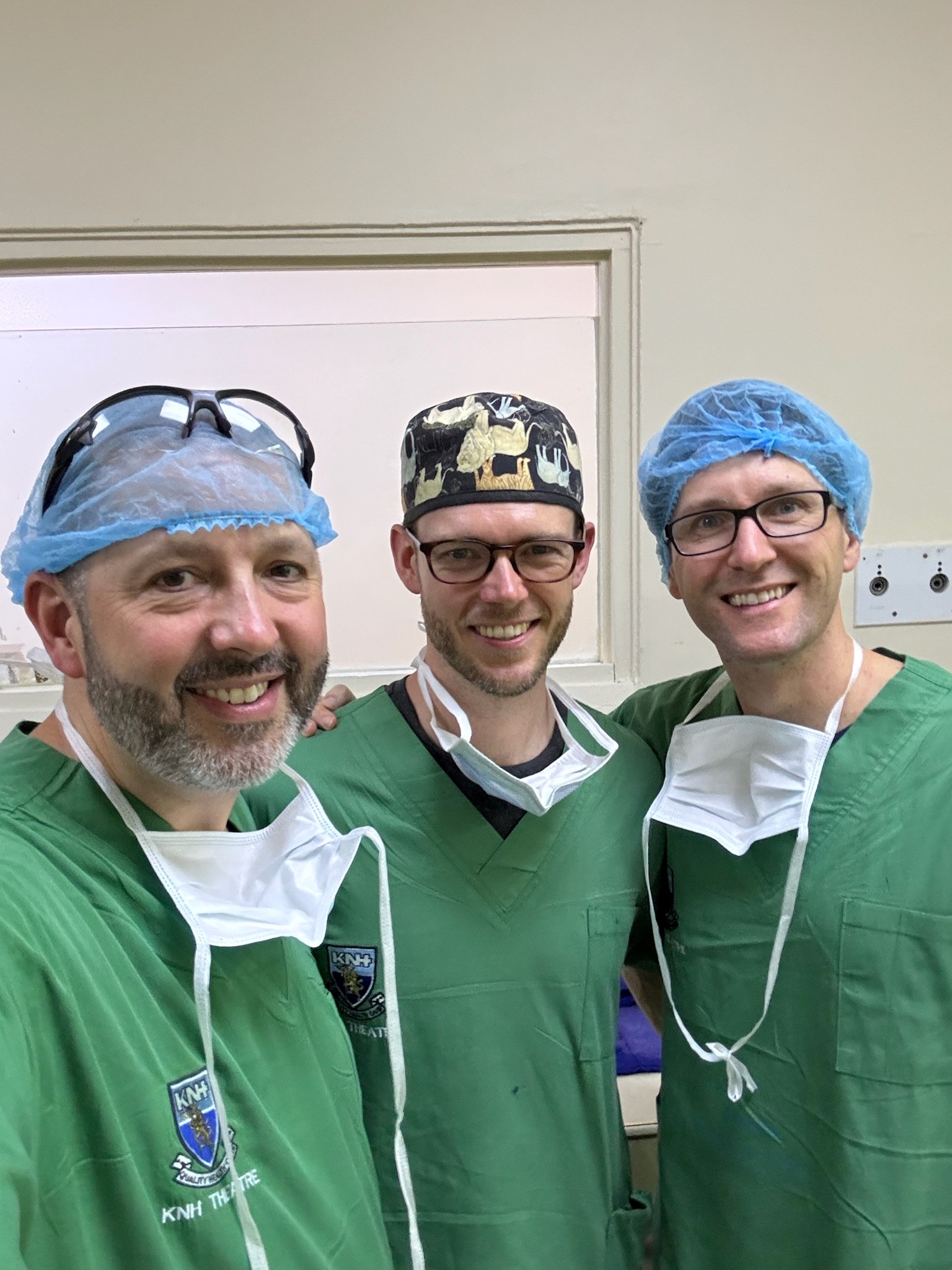 A selfie of three otolaryngologists scrubbed in.