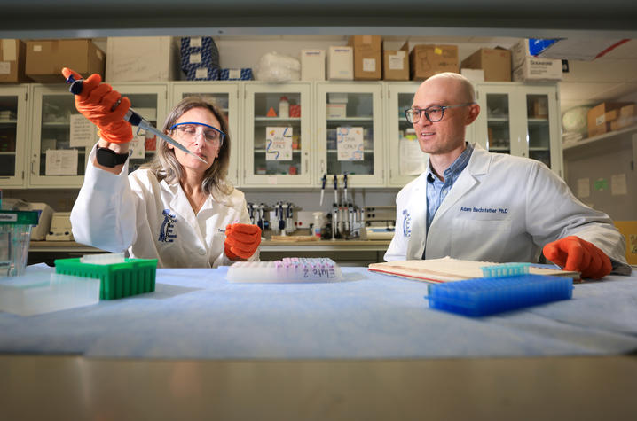 Teresa Macheda and Adam Bachstetter, PhD, conduct research in Bachstetter’s lab at the University of Kentucky.