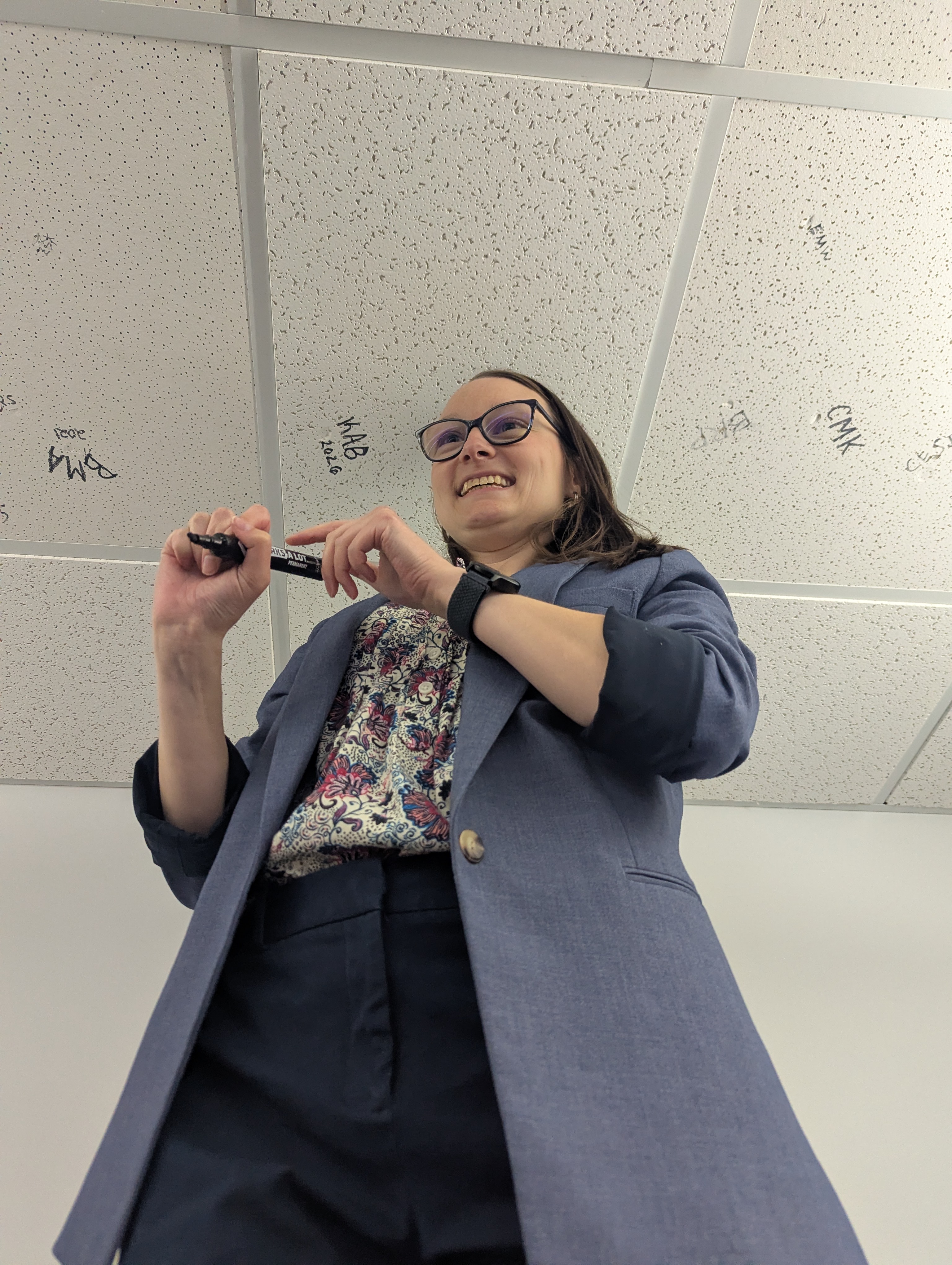 Dr. Bullens signs the ceiling as a part of a longstanding department tradition. 