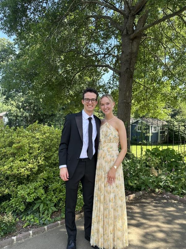 Alec standing with his wife for a wedding