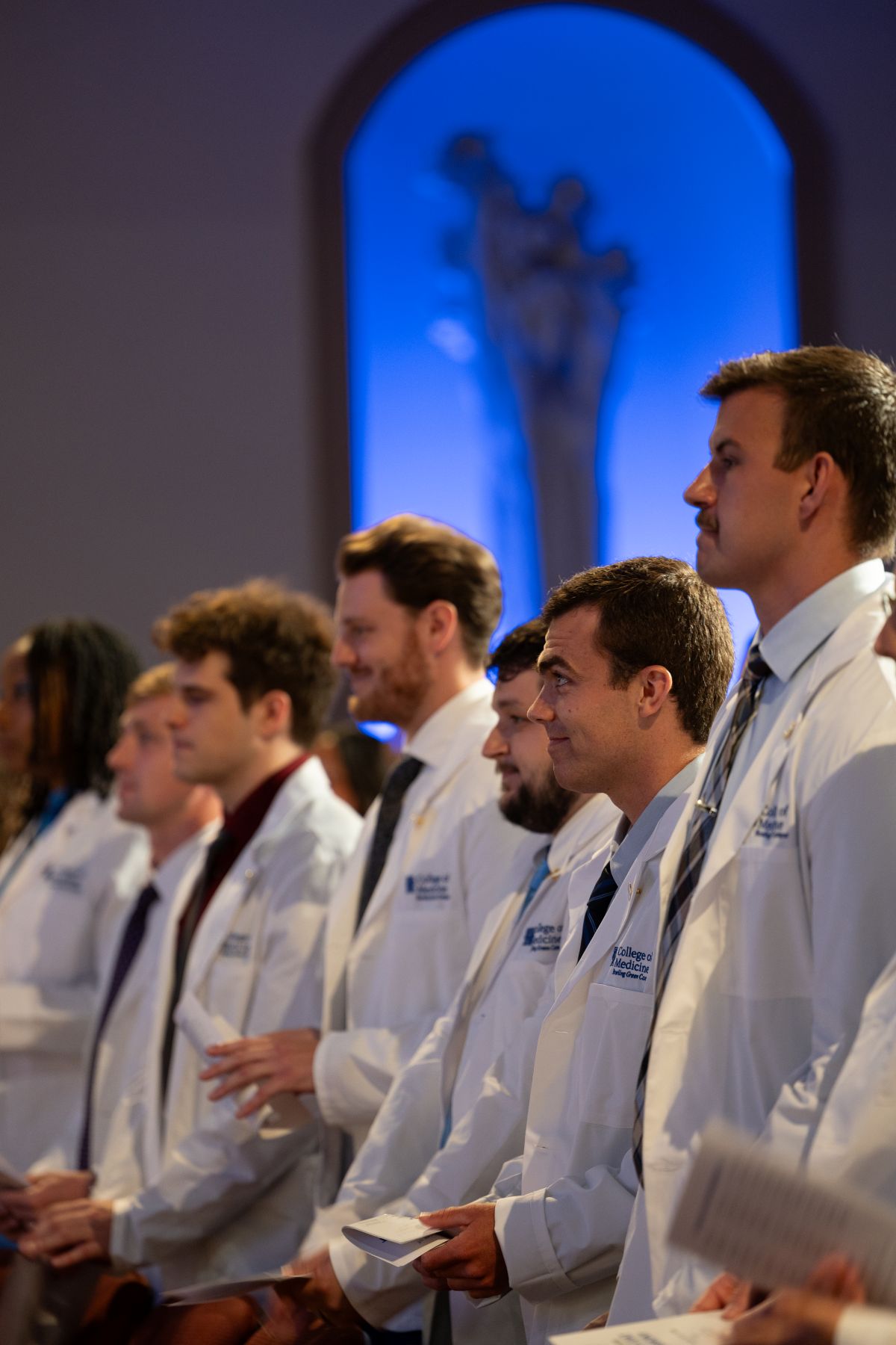 Row of medical students in white coats 