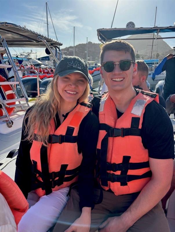 Maddy Edwards sitting in a life jacket with her husband on a boat