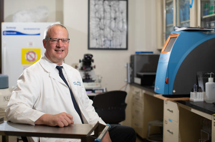 Image of Dr. Nelson sitting at a desk