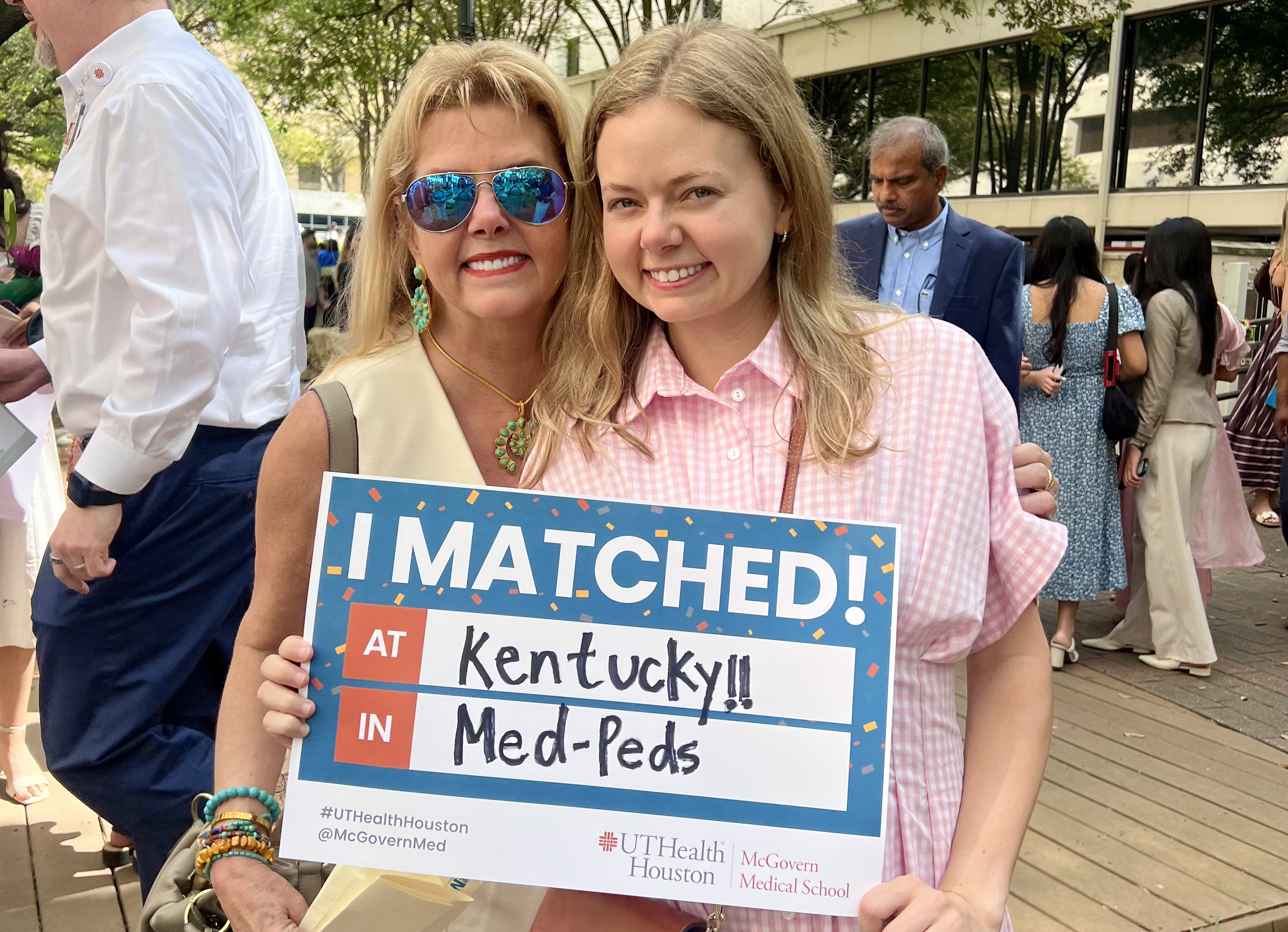 Anna Claire Taylor and her mother at UK MatchDay. They are holding a sign that says, "I MATCHED! At Kentucky In Med/Peds"