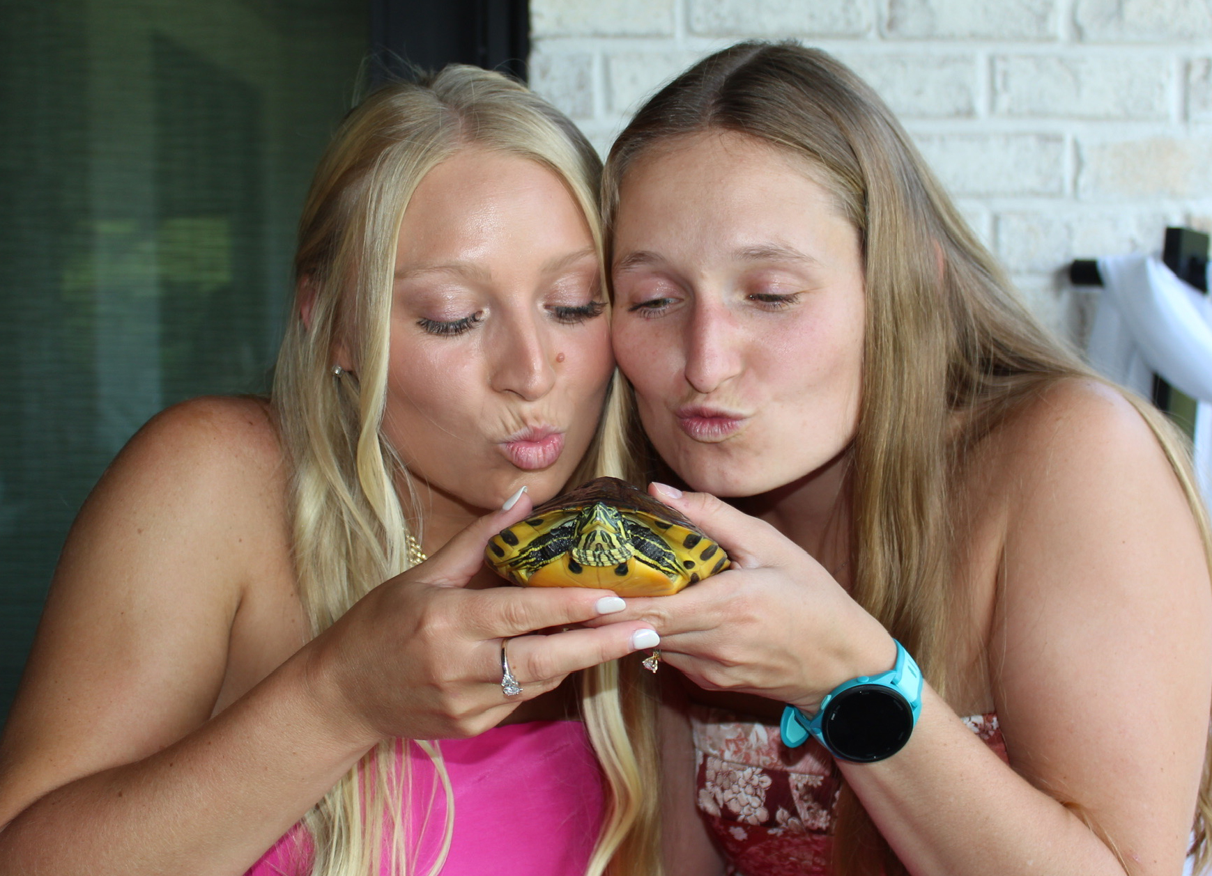 Eva Weitkamp and a friend holding a turtle and making a kissy face at it.