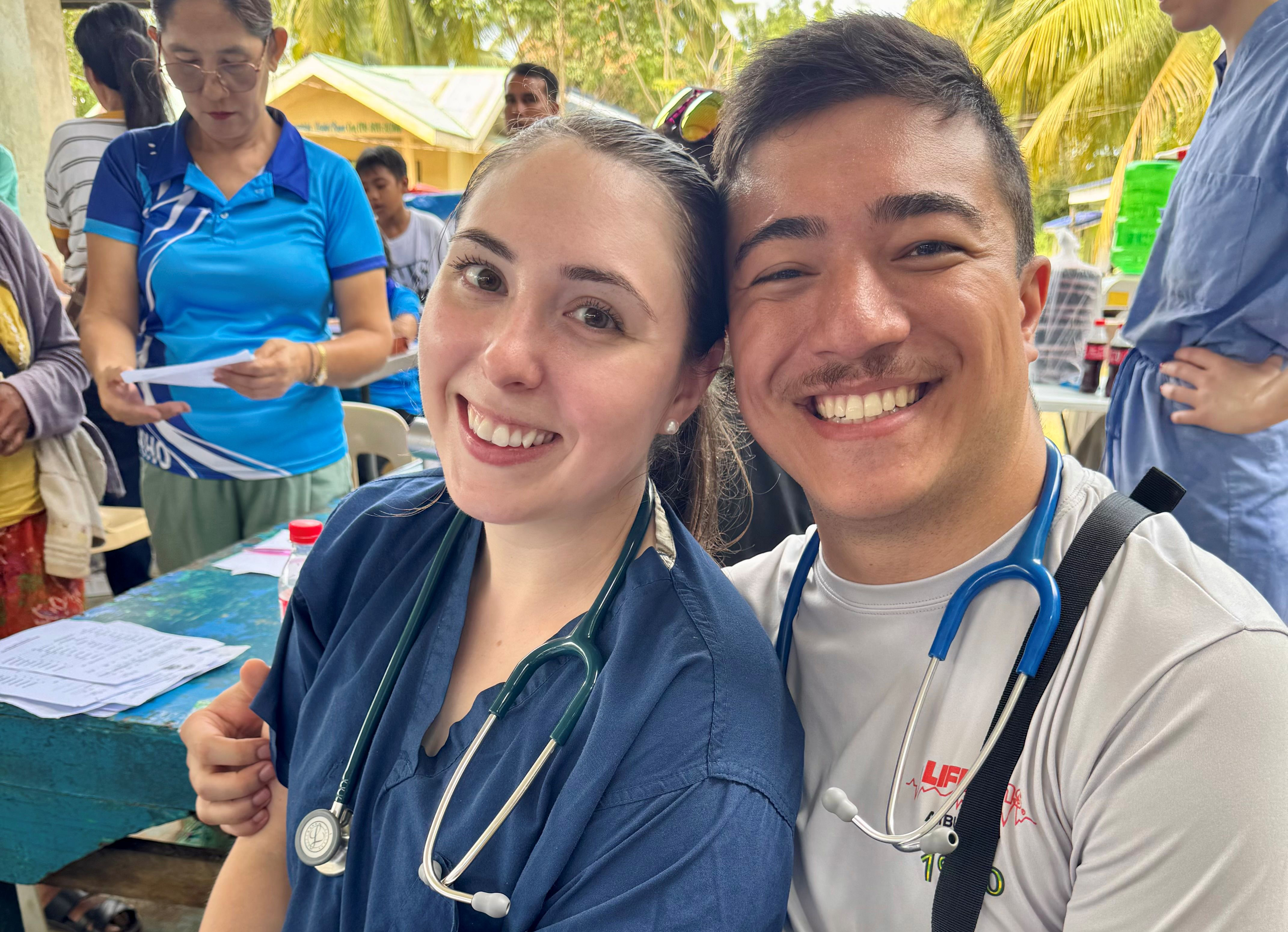 Lacey Burke and Deegan working at the Philippines Clinic