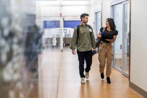 Two UK College of Medicine students walk in the M73 library
