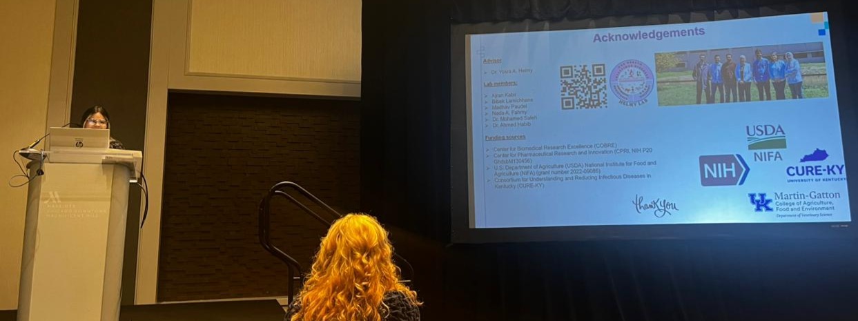 Rosbelly Rios Rodriguez delivering an oral scientific presentation at the Conference of Research Workers in Animal Diseases (CRWAD), with her acknowledgements slide displayed on screen.