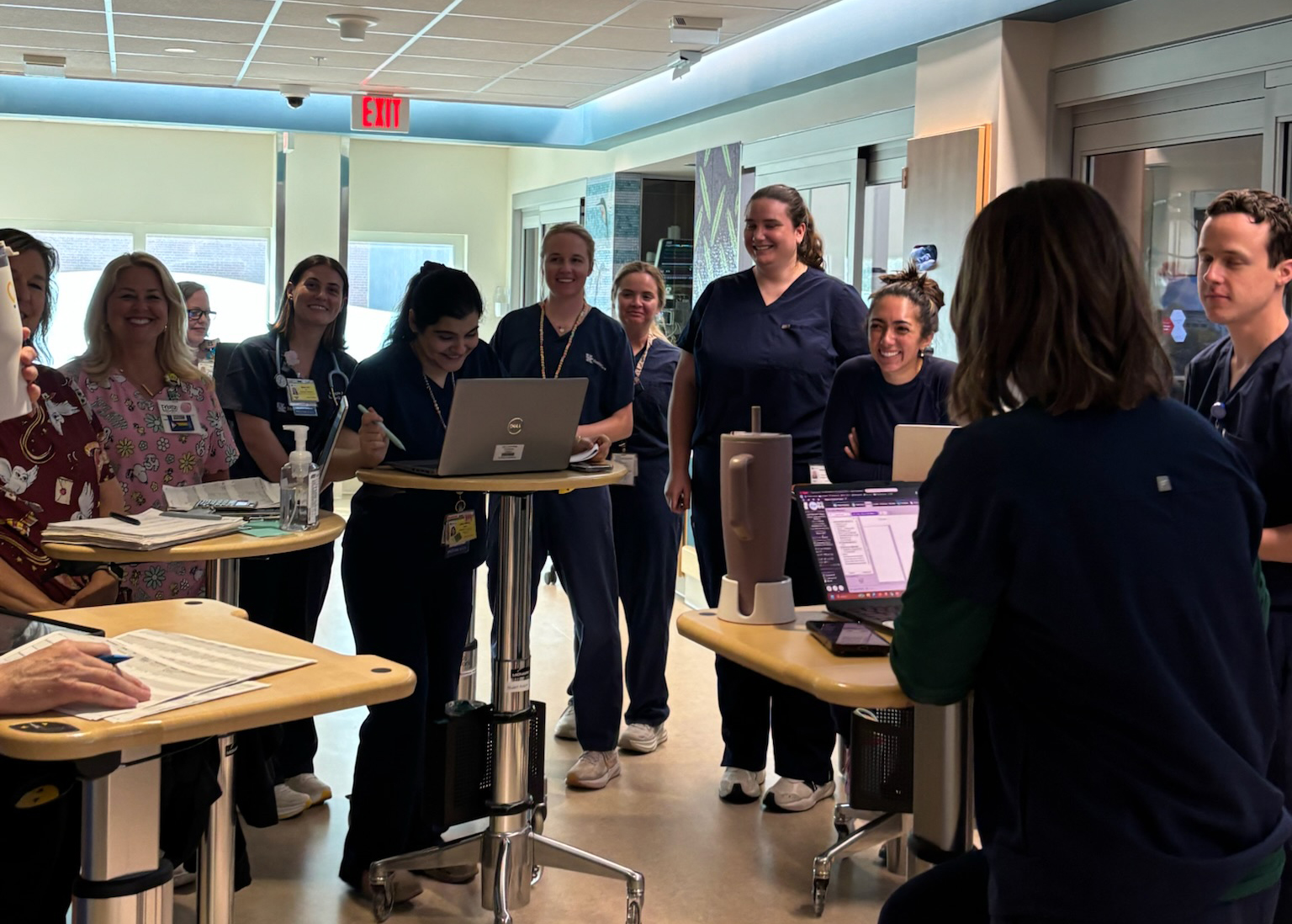 Medical Professionals gathered in a circle with mobile workstations.