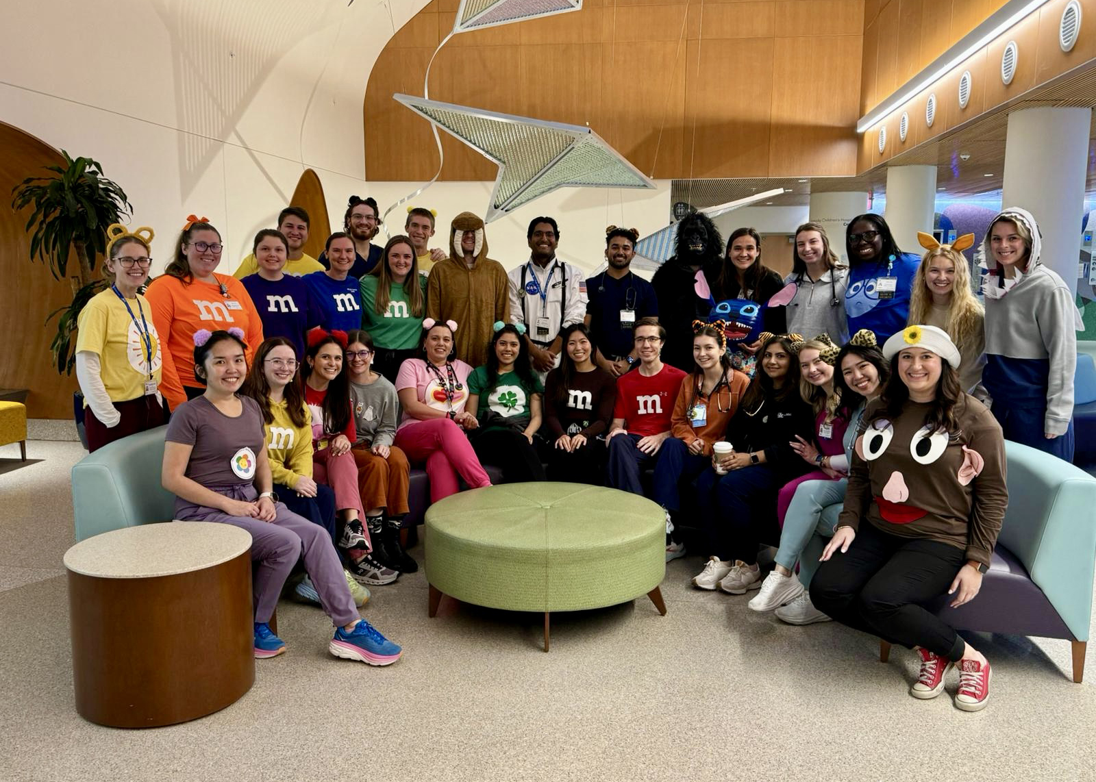 The pediatric team gathered together in the lobby of the children's hospital, wearing halloween costumes.
