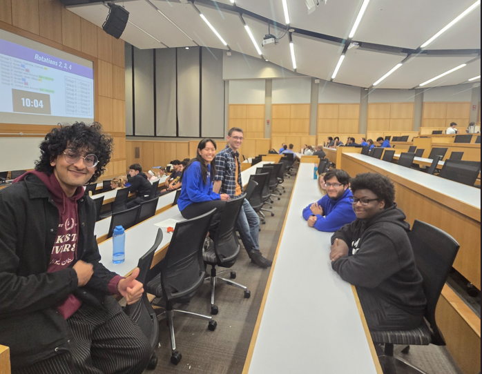 Medical student poses with group of undergraduate students during Medicats discussion
