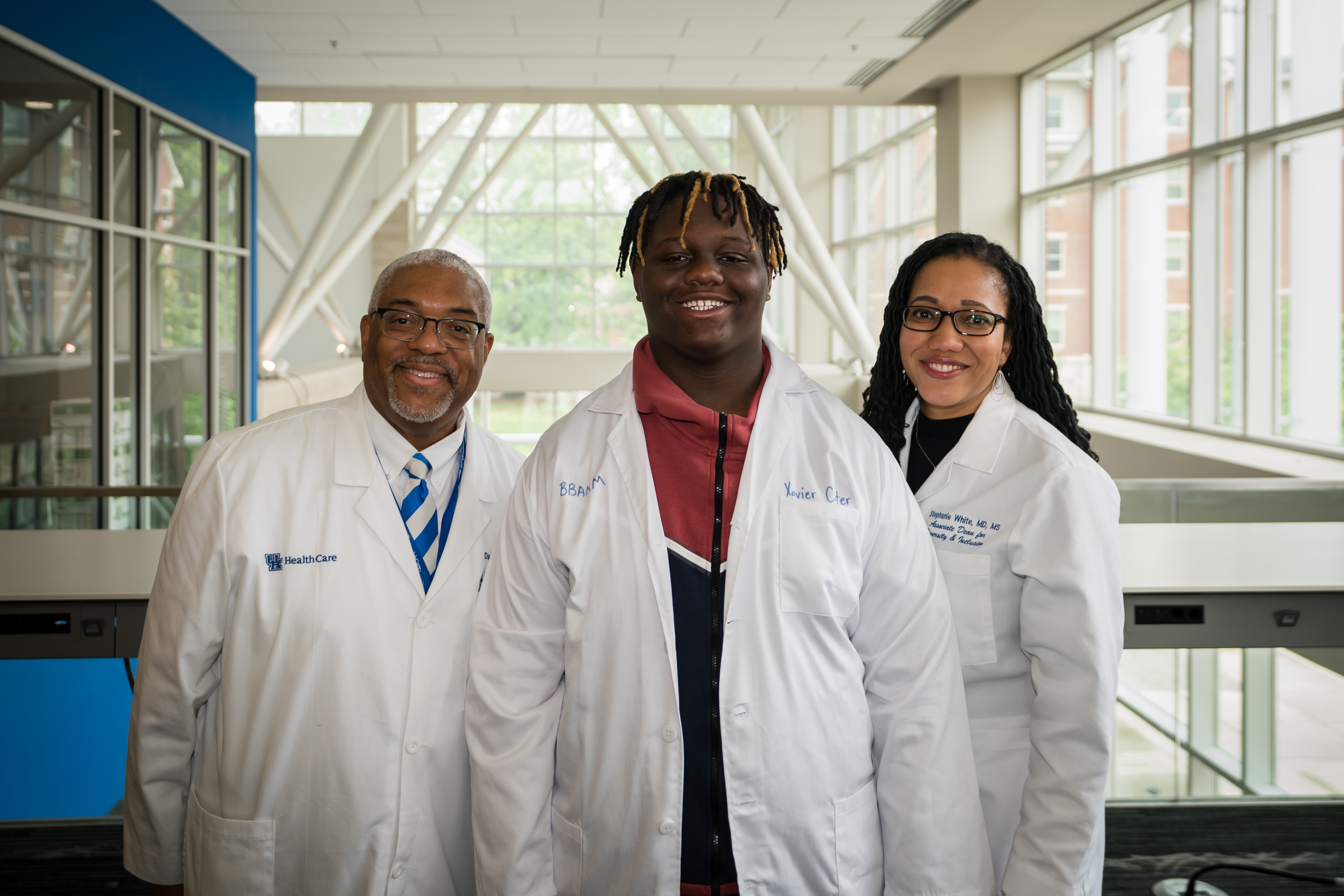 Dr. Darwin Conwell and Dr. Stephanie white pose with a student