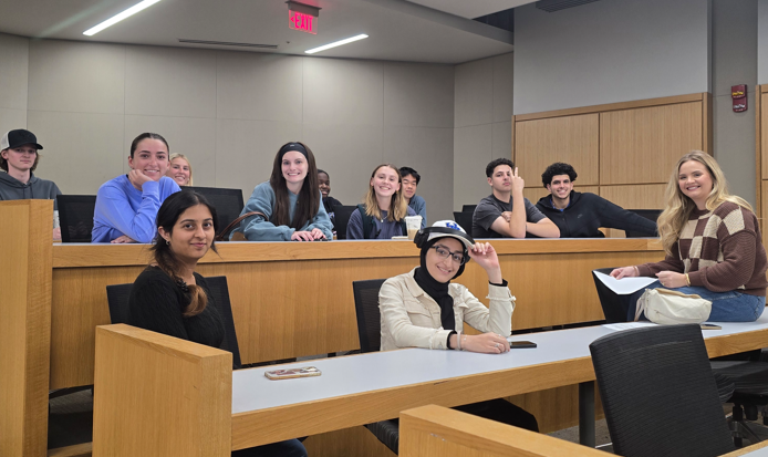 Medical student poses with group of undergraduate students during Medicats discussion