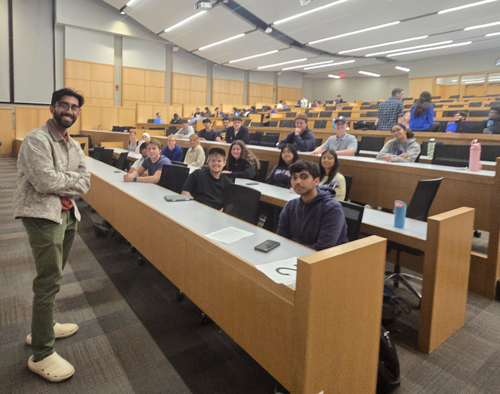 Medical student poses with group of undergraduate students during Medicats discussion