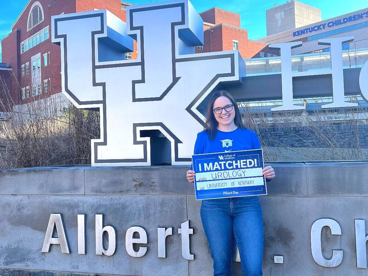 Dr. Kate Spencer holds "I matched" sign outside UK's Chandler hospital 