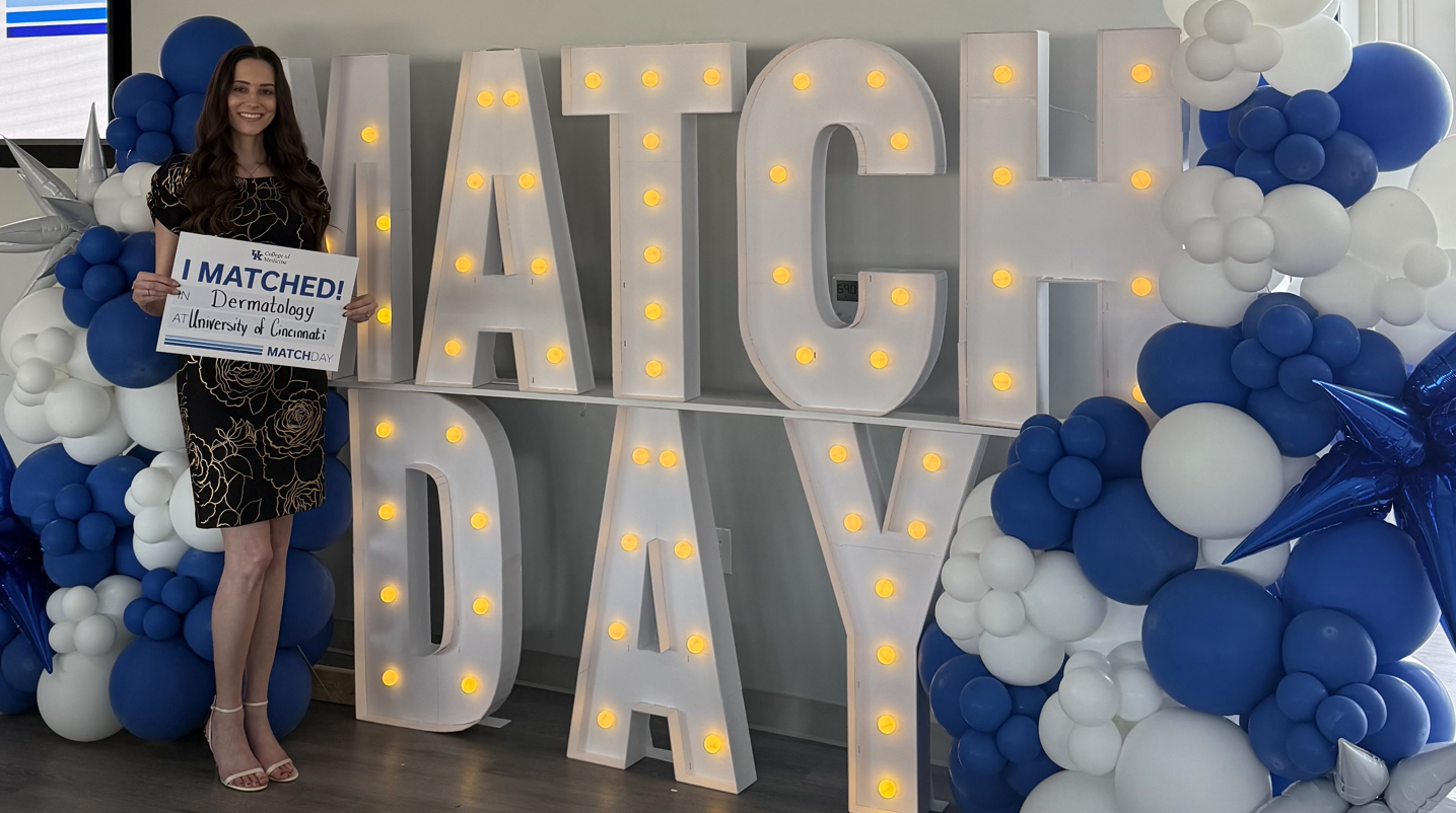 Alicia on Match Day holding an "I Matched" sign