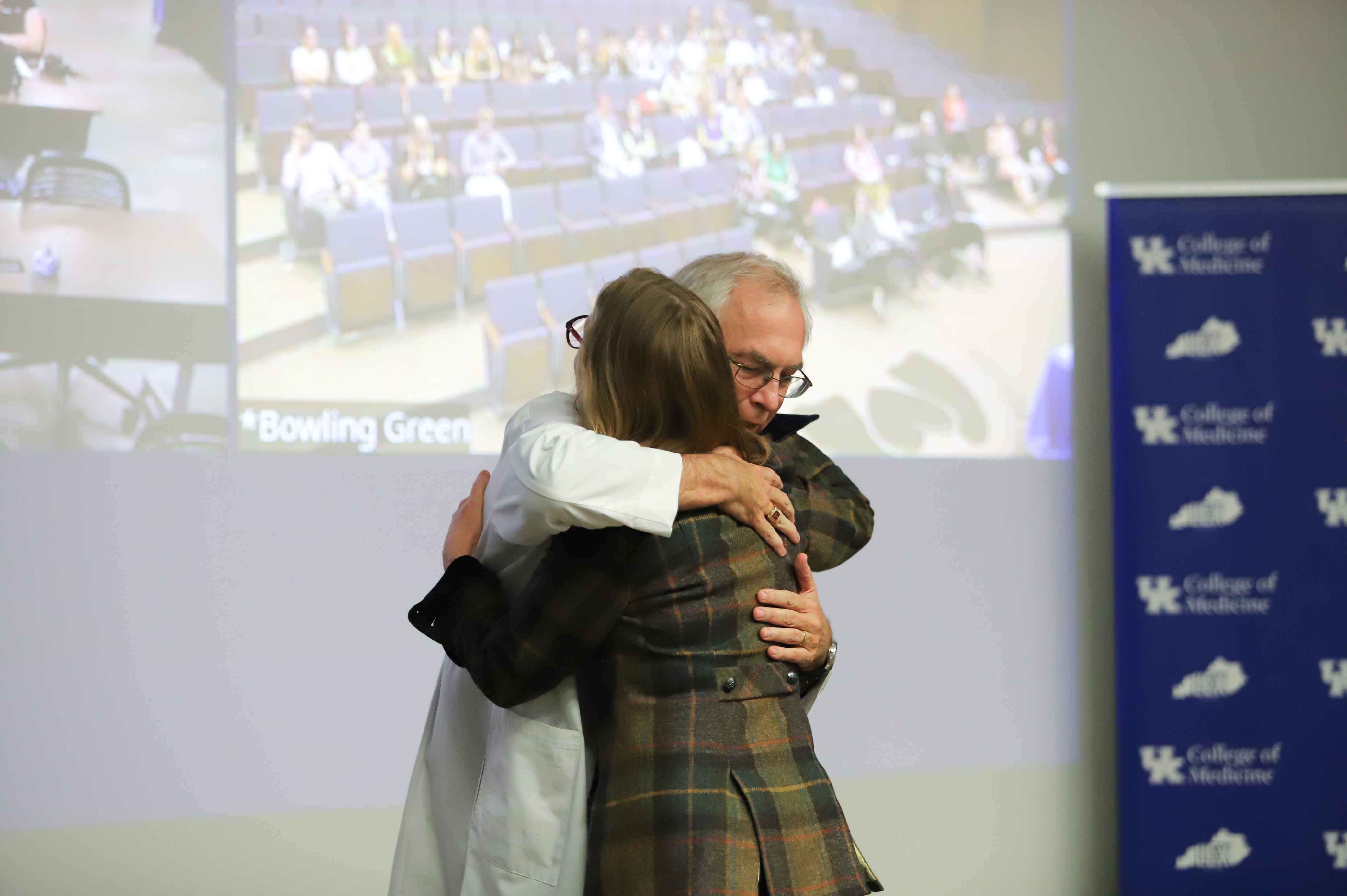 Dr. Griffith and Dr. Arnold hug during awards presentation