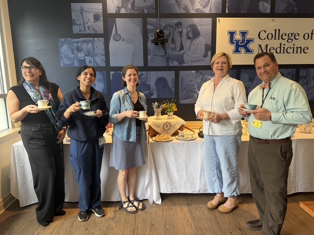 Participants at past CreativiTEA pose for a photograph holding their teacups