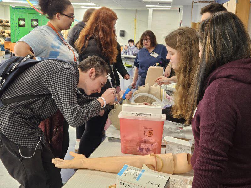 students practice suturing techniques at hs outreach event 