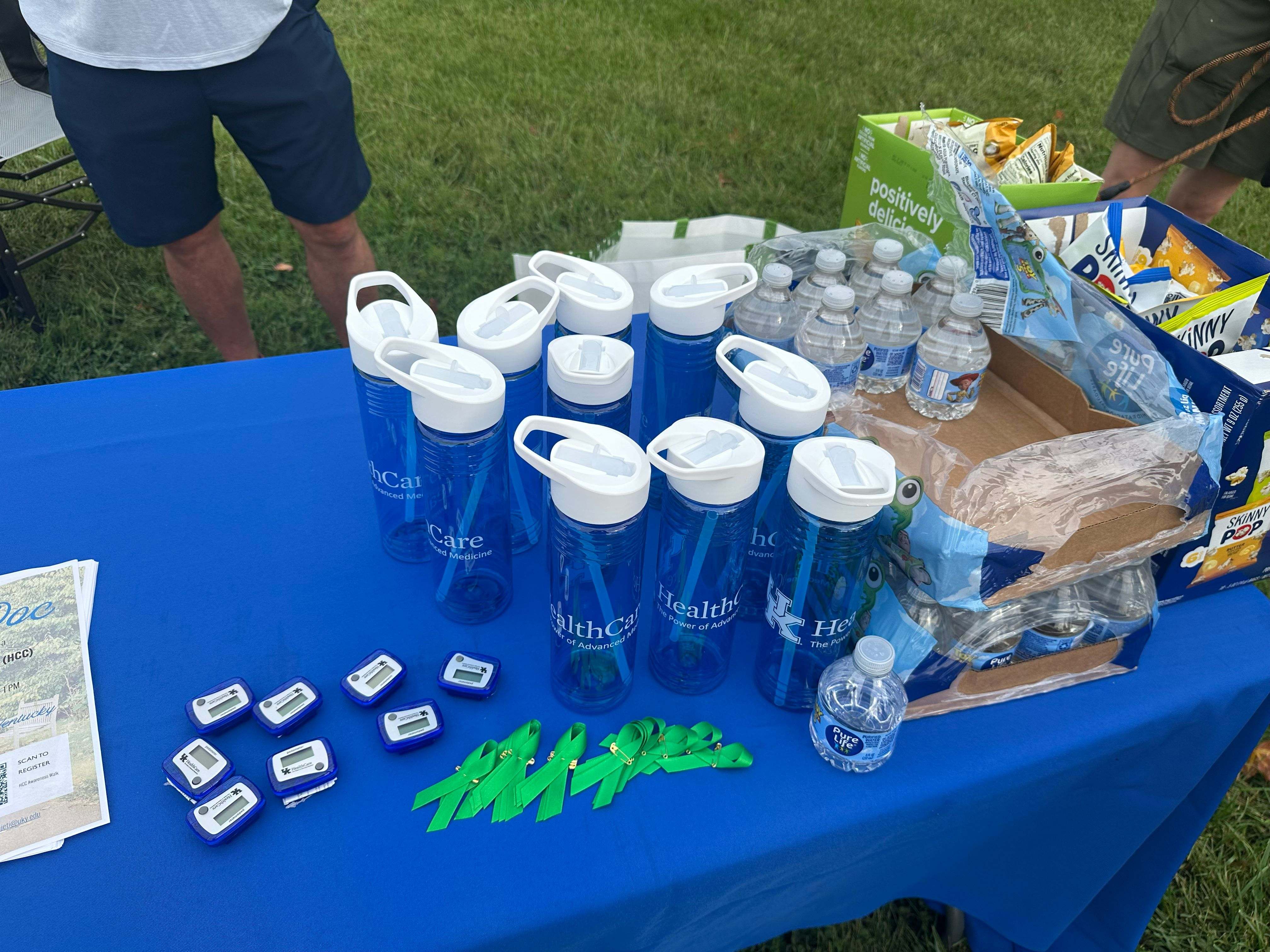 check in table with pedometeters, green ribbons, water bottles, water and snacks