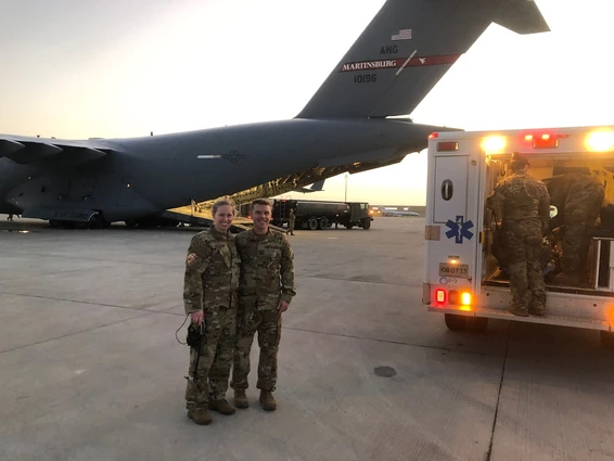 Dr. Chris Belcher handing off a patient to one of his colleagues on ground at airport