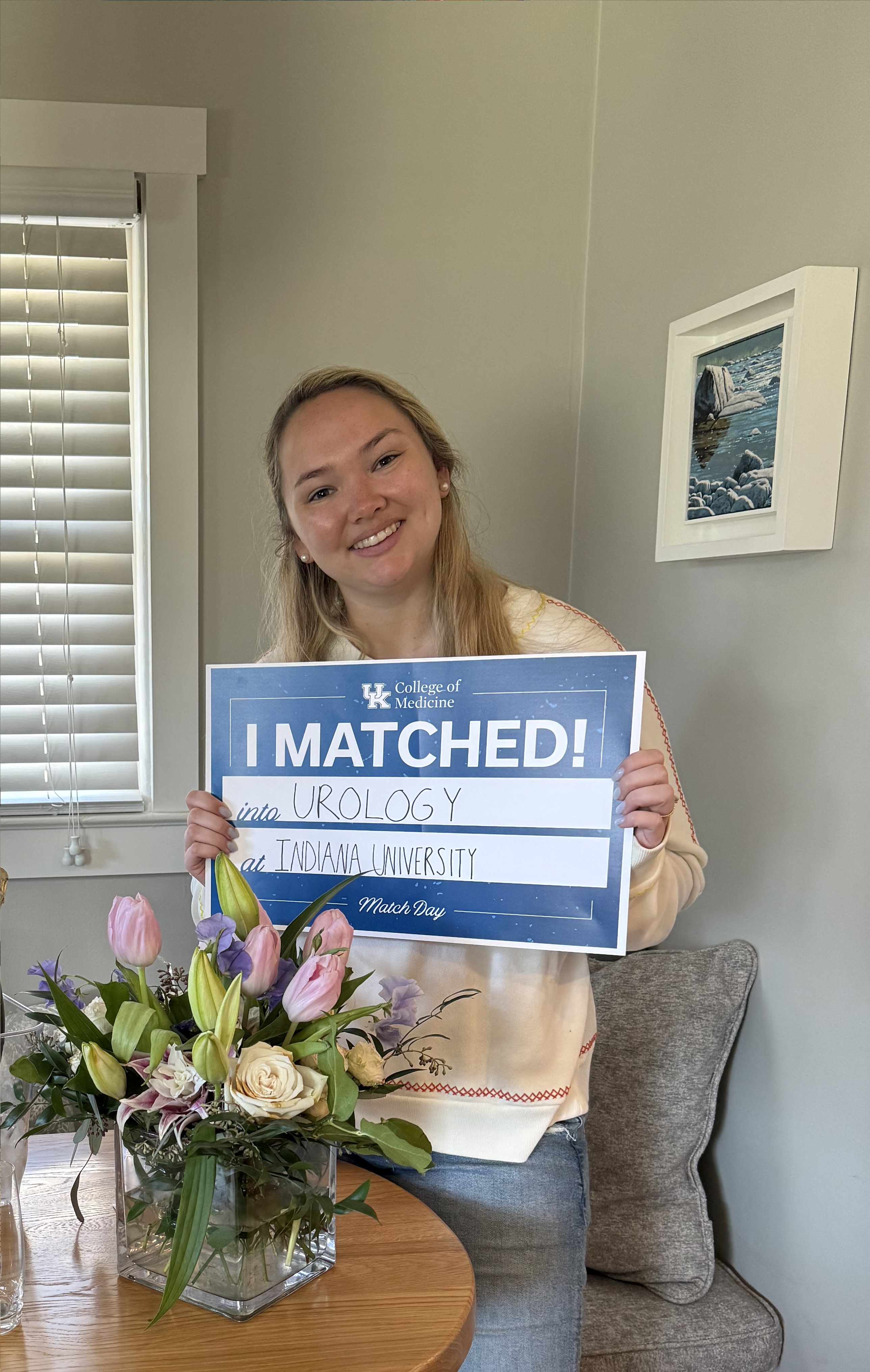 Med student holding "I matched" sign 