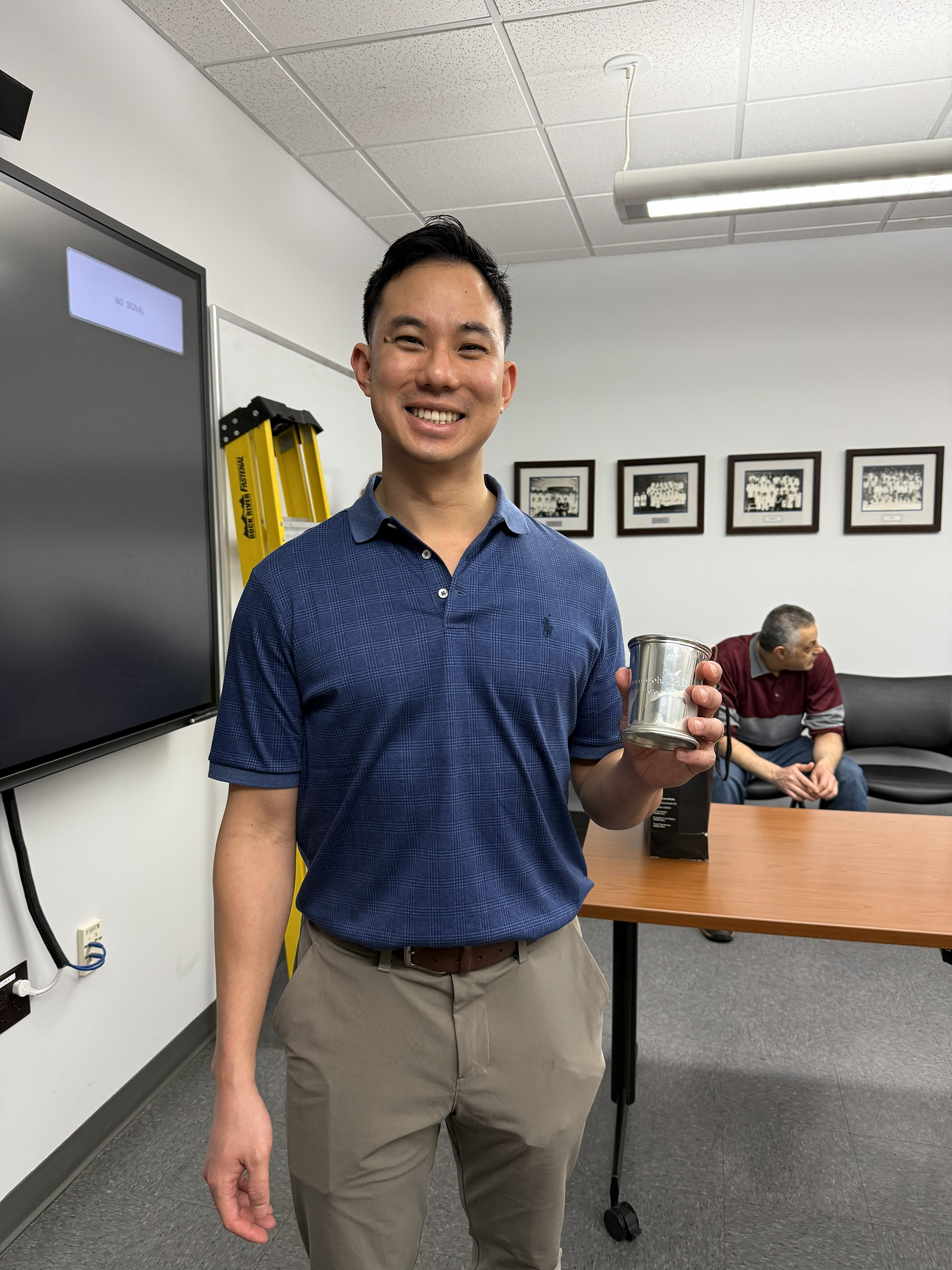 Jensen Goh holds his congratulatory julep cup for earning his PhD. 