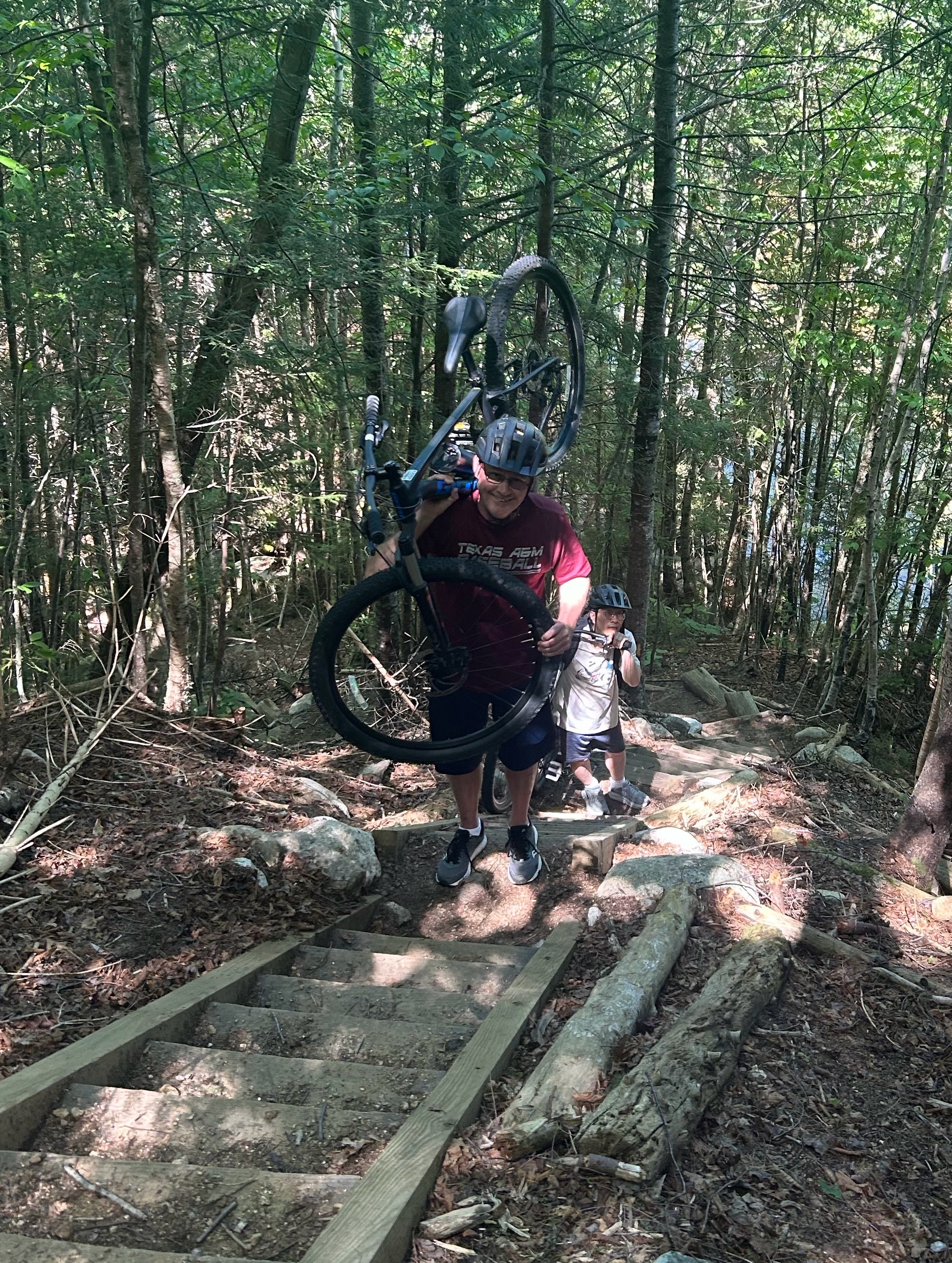 Greg Graf ascends stairs with a mountain bike. 
