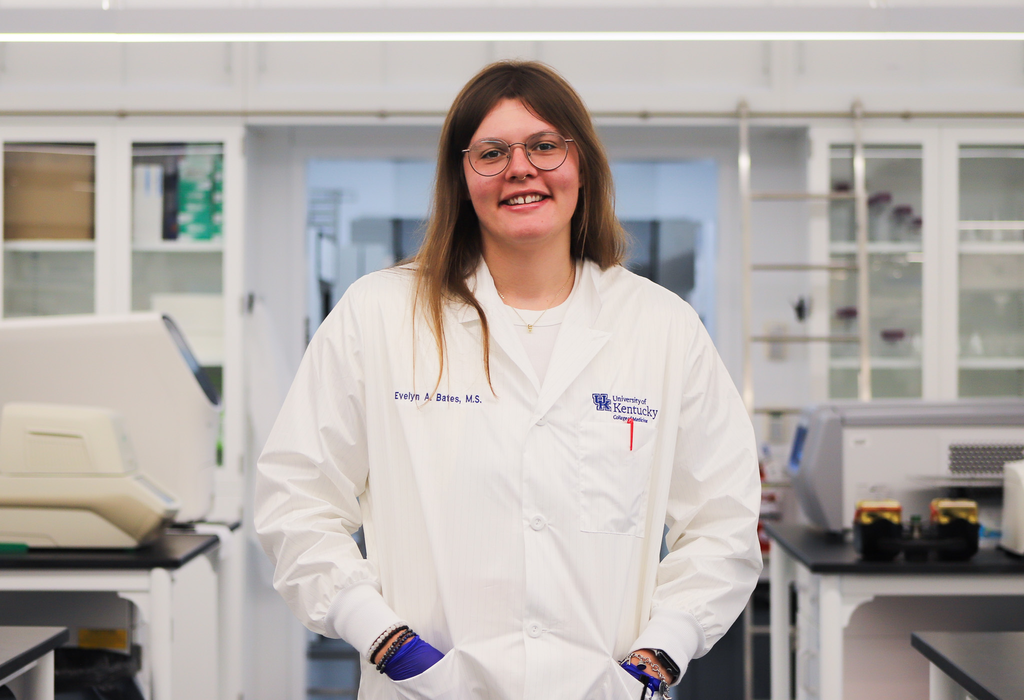 Evelyn poses in her white coat inside the lab