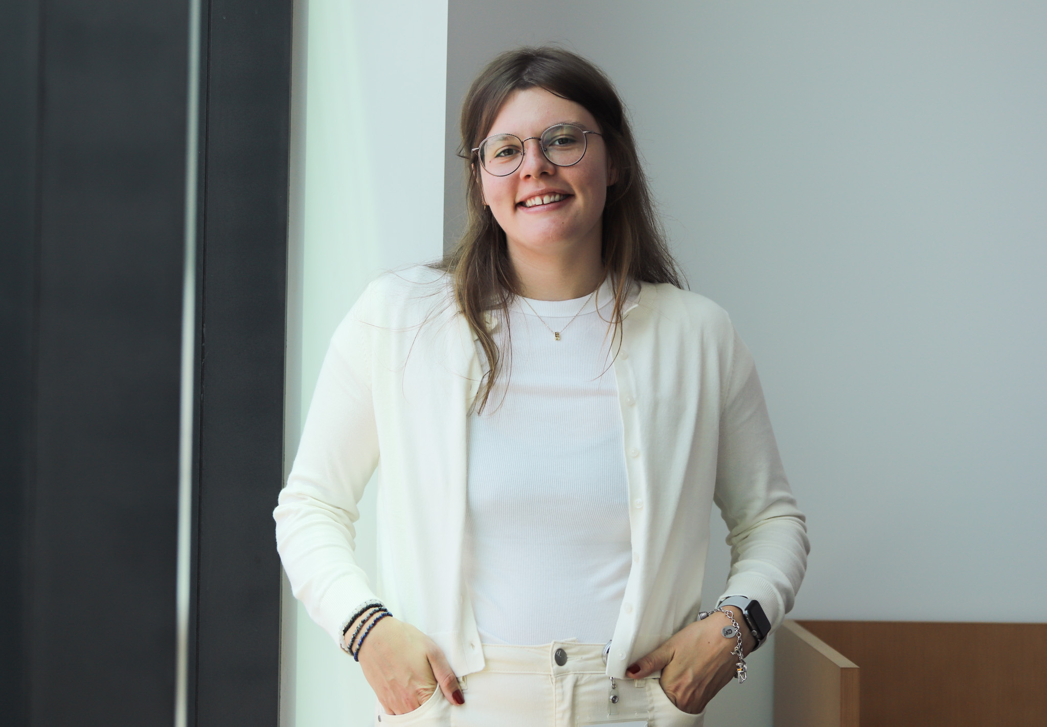 Evelyn poses in white clothes, outside the lab