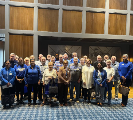 The group of speakers and attendees gathers for a photo.