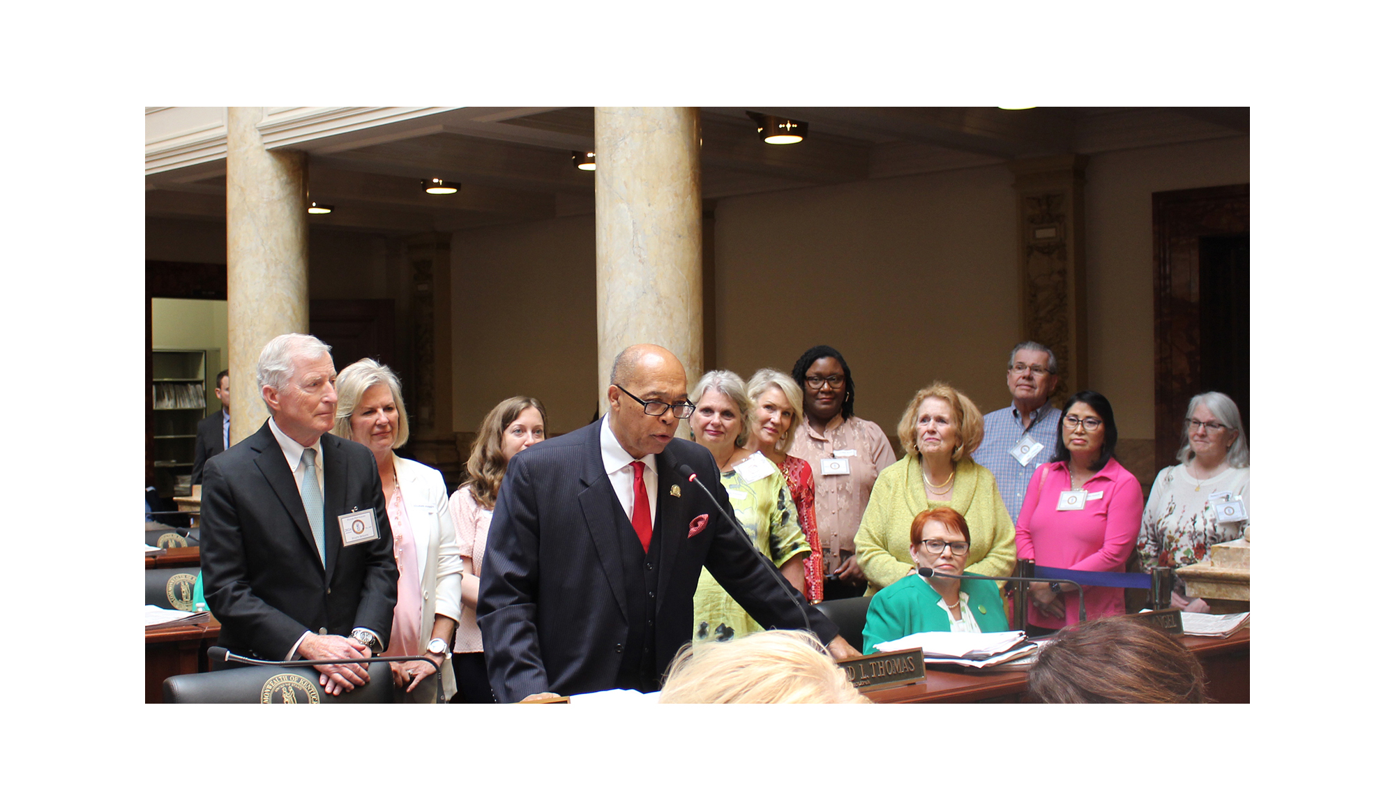 Group accompanying Dr. McGrath on senate floor during reading of honorary resolution.