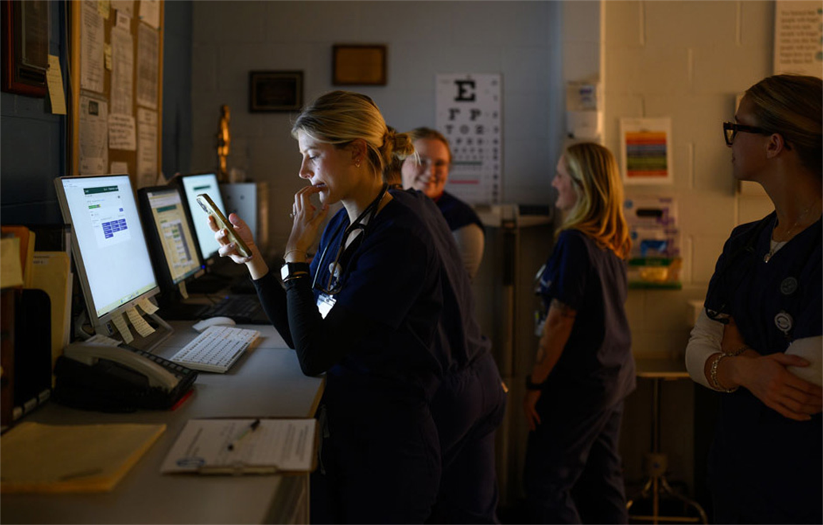 Medical students preparing for clinic: L to R Annie Smock (with phone), Mollie Flanagan, Nicole Marker and Lizzie Hornung