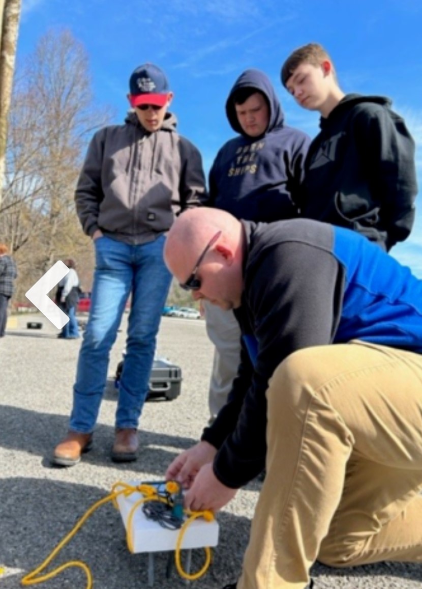 Craig Wilmhoff and students preparing their drone for the citizen science project in Perry County.