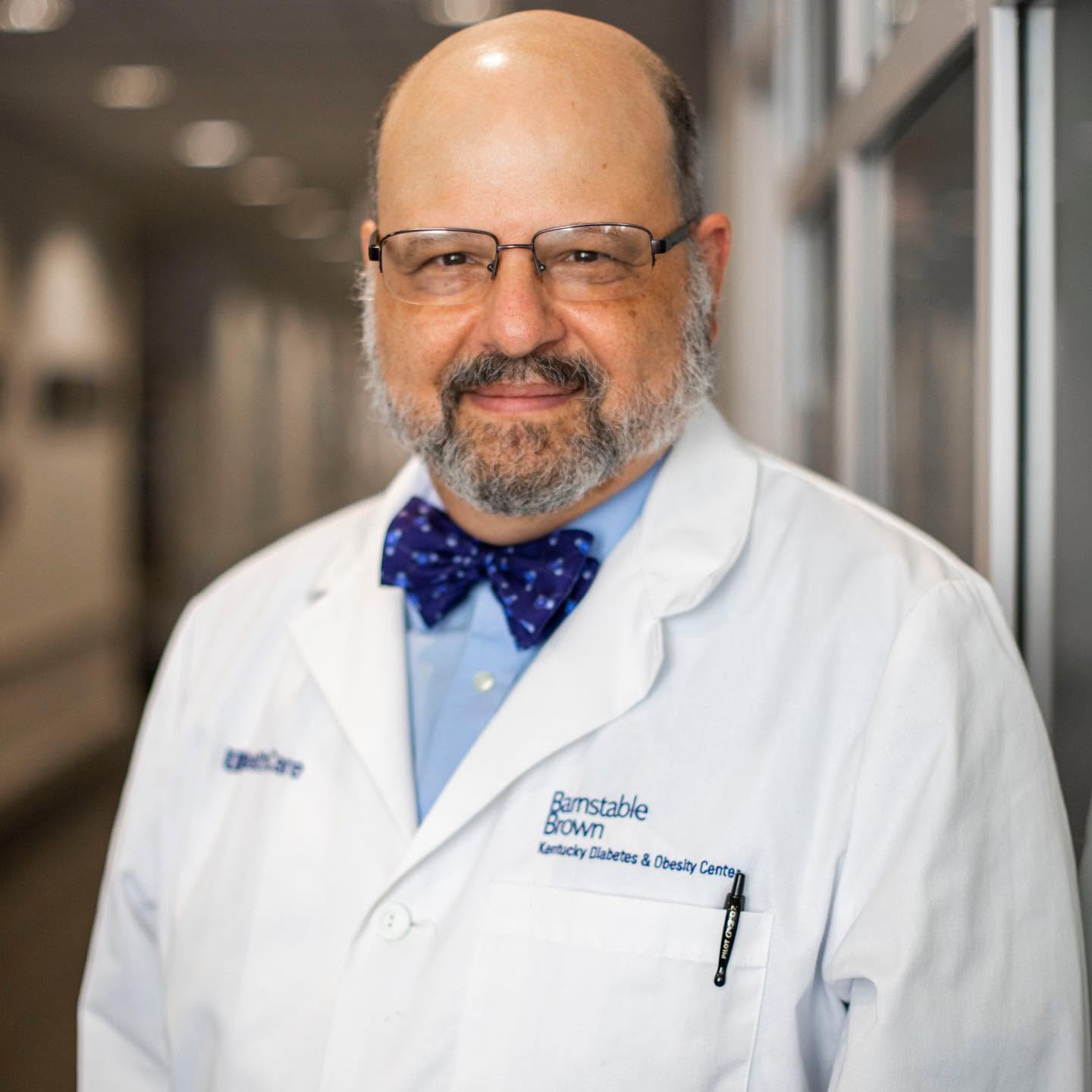 Dr. Whiteheart wearing a bowtie and white coat that reads Barnstable Brown Diabetes Center 