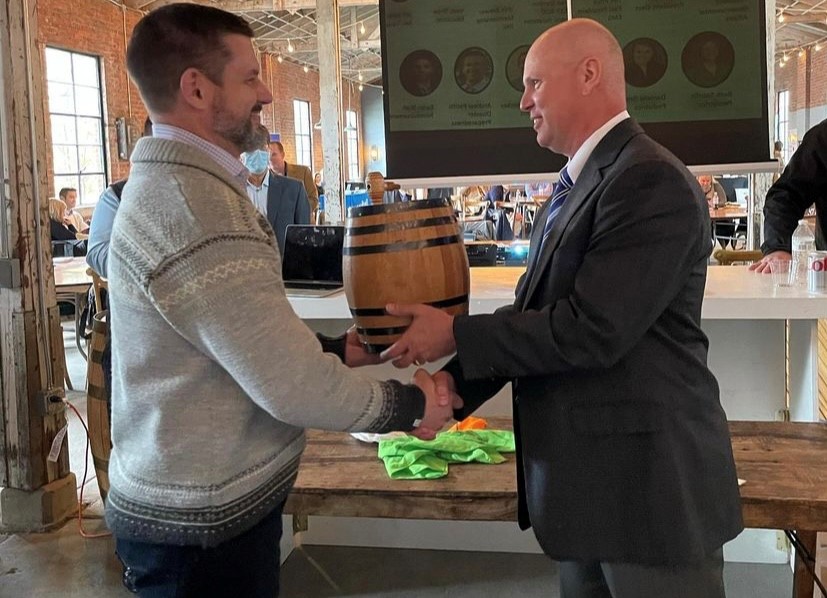 handing off of barrel trophy to UK resident