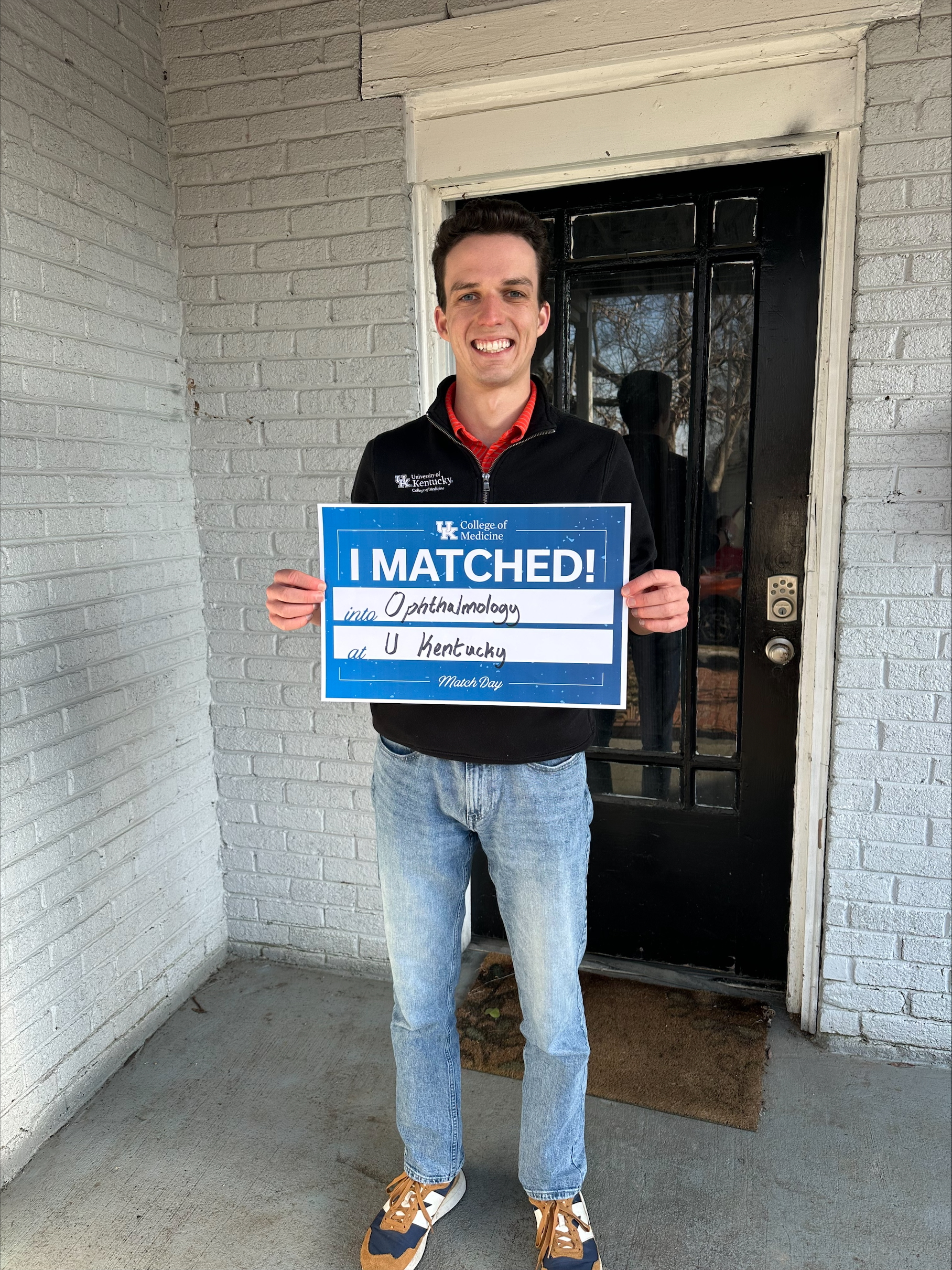 Med student holding "I matched" sign 