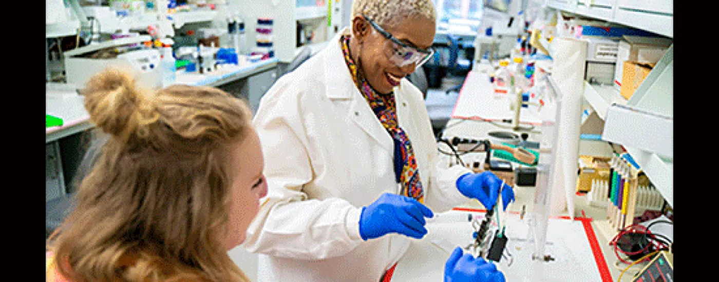 Dr. Yvonne Fondufe-Mittendorf in laboratory with unnamed person