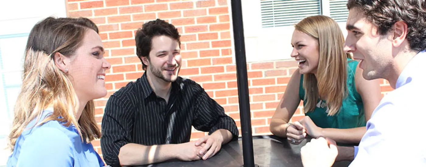 Students conversing at a table
