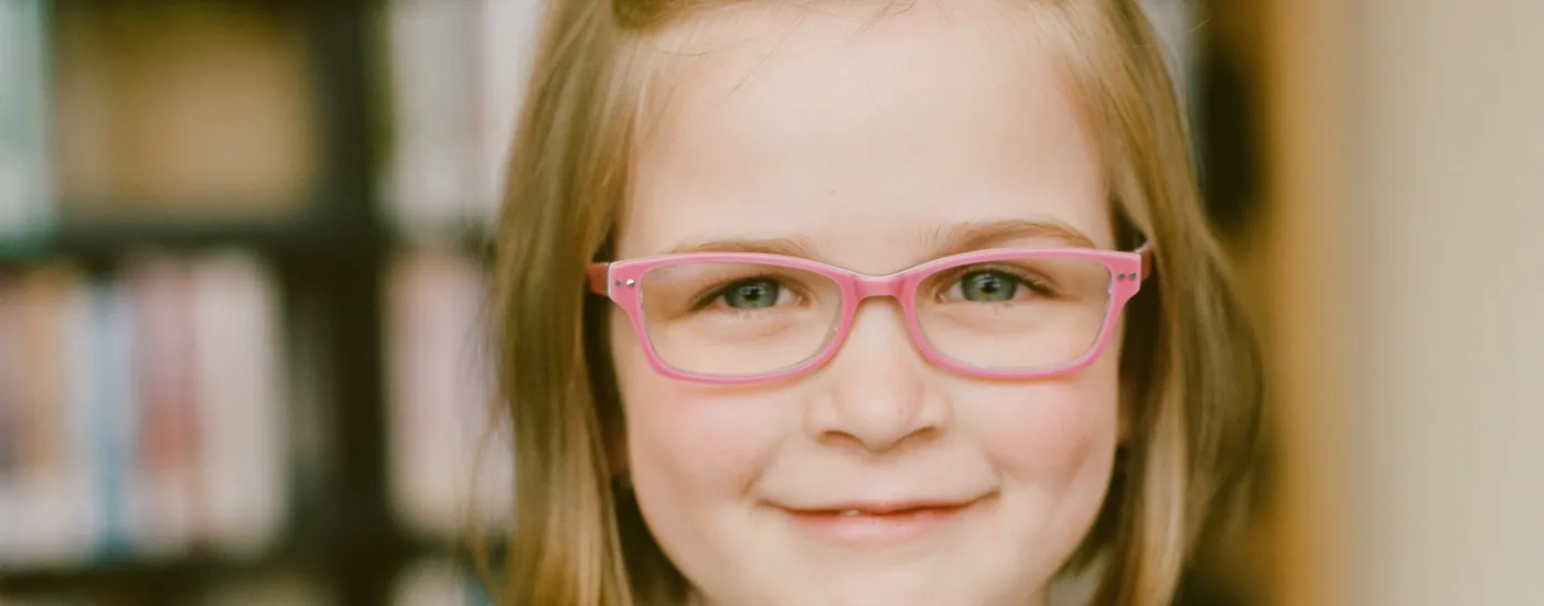 Little girl wearing glasses.