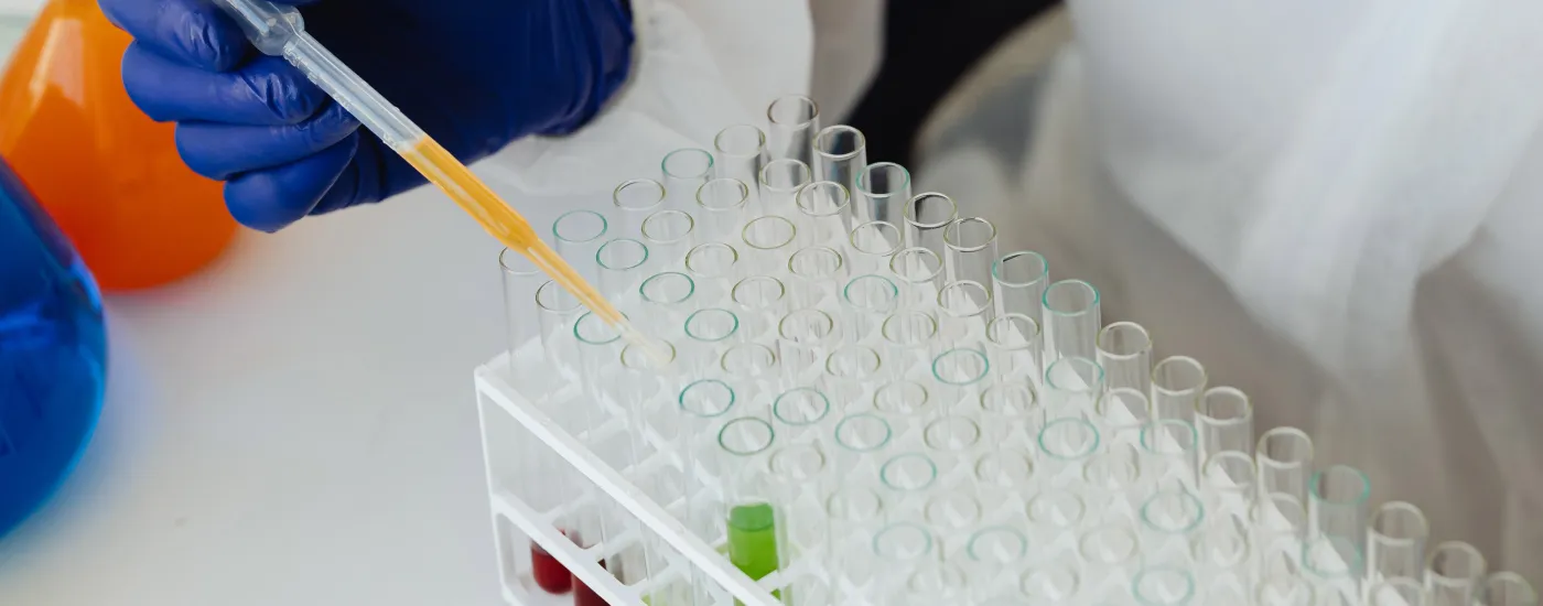 researcher with vials and syringe