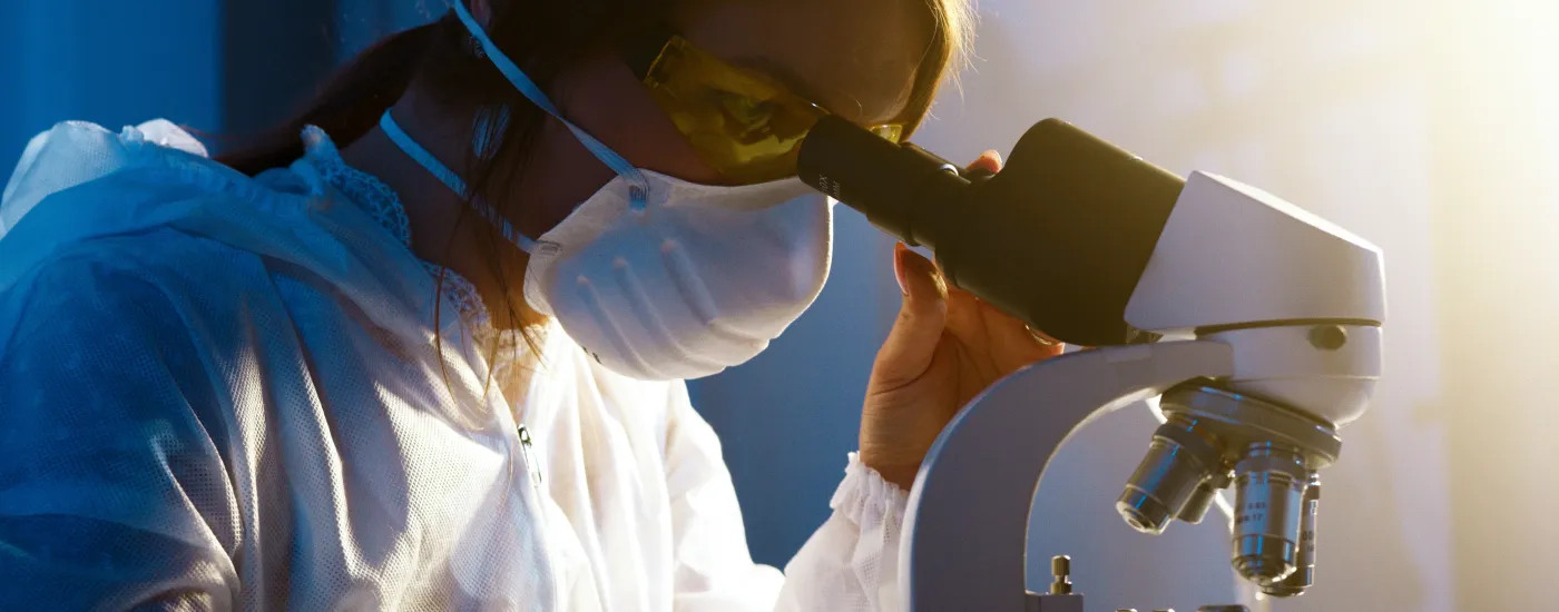 woman using microscope
