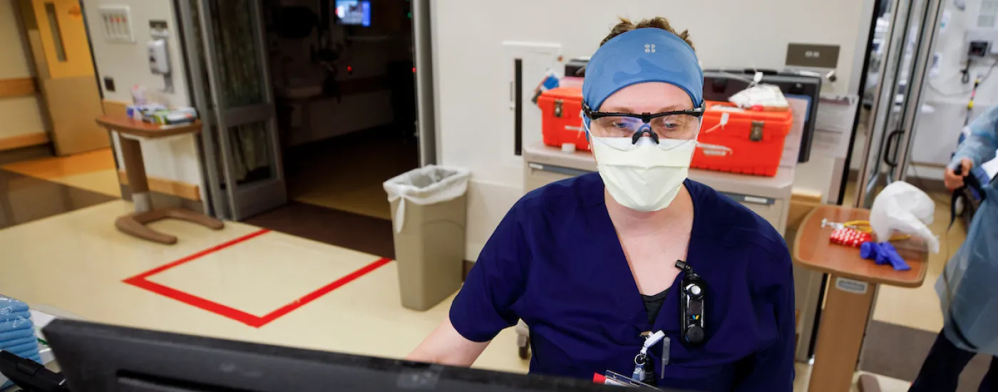 provider in emergency department looking at computer screen