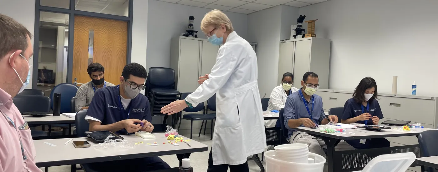 Dr. Bocklage teaching using Play Doh during Intro to Grossing.
