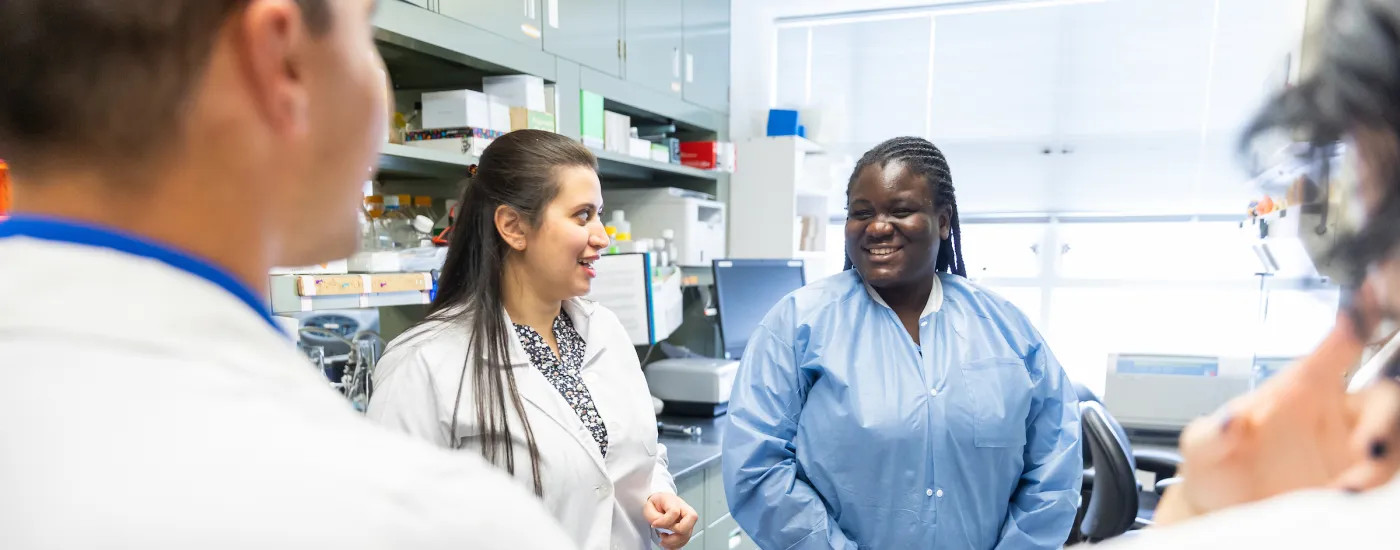 student researcher talking in a lab