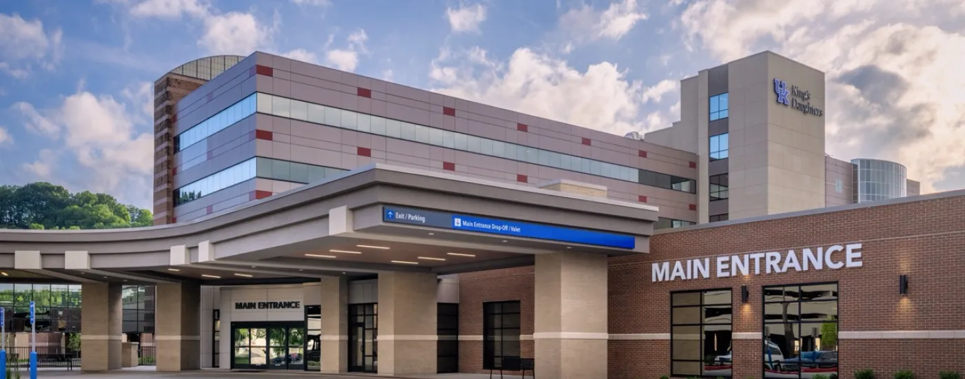 Exterior of UK King's Daughters Medical Center with a cloudy sky background