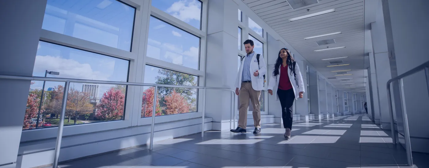 students walking through a bridge with a blue overlay